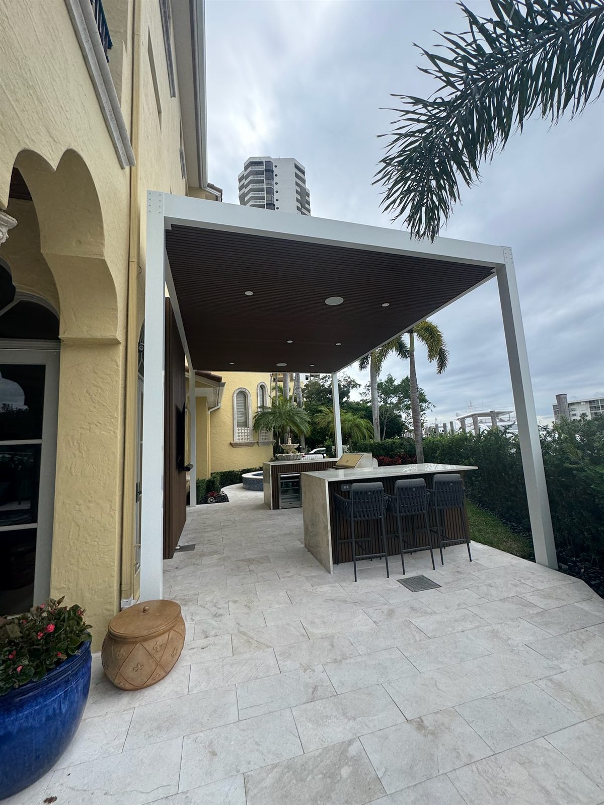 Pergola over a marble-top bar with palm views