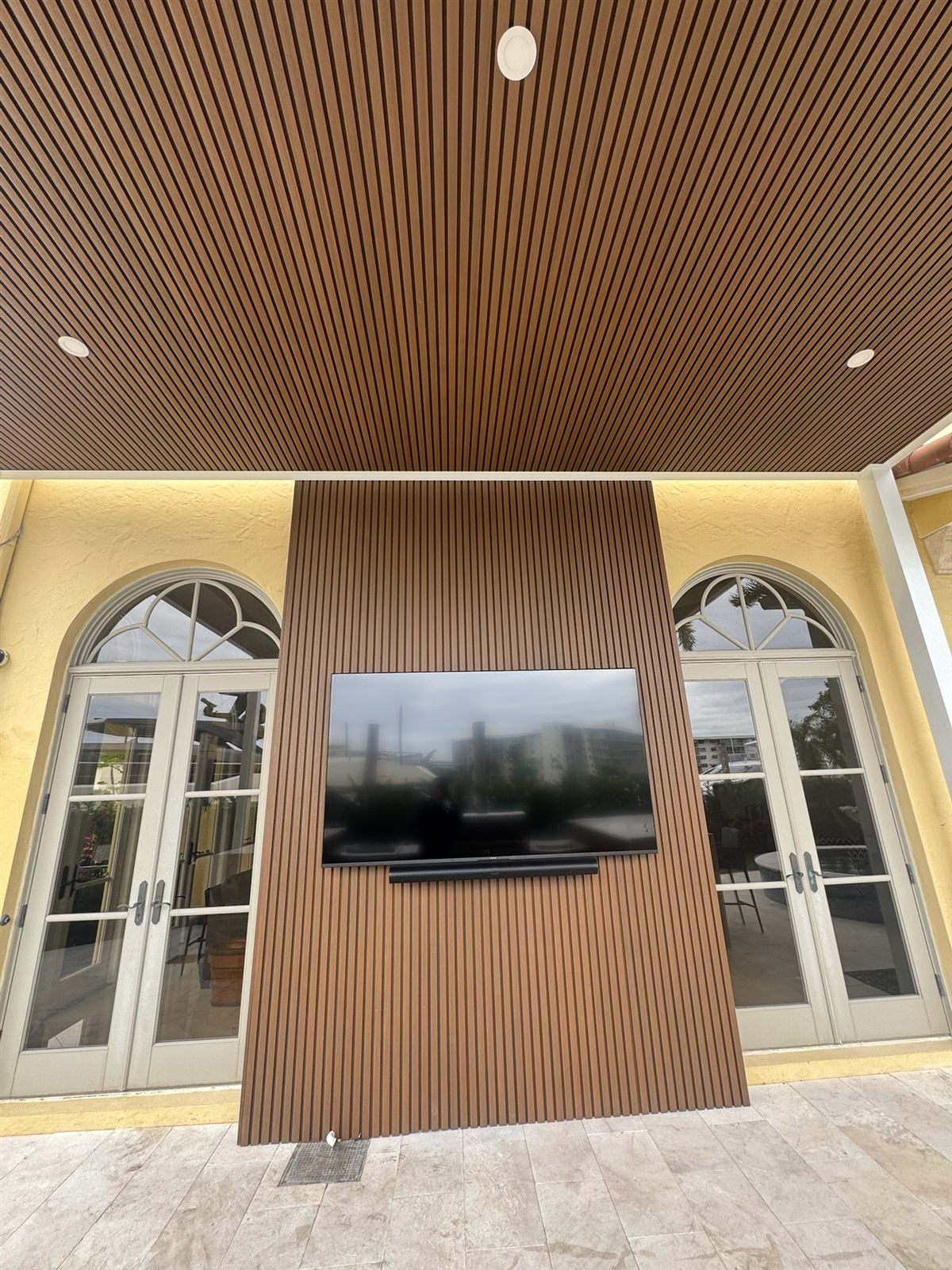 Close-up of the fluted-wood ceiling and feature wall