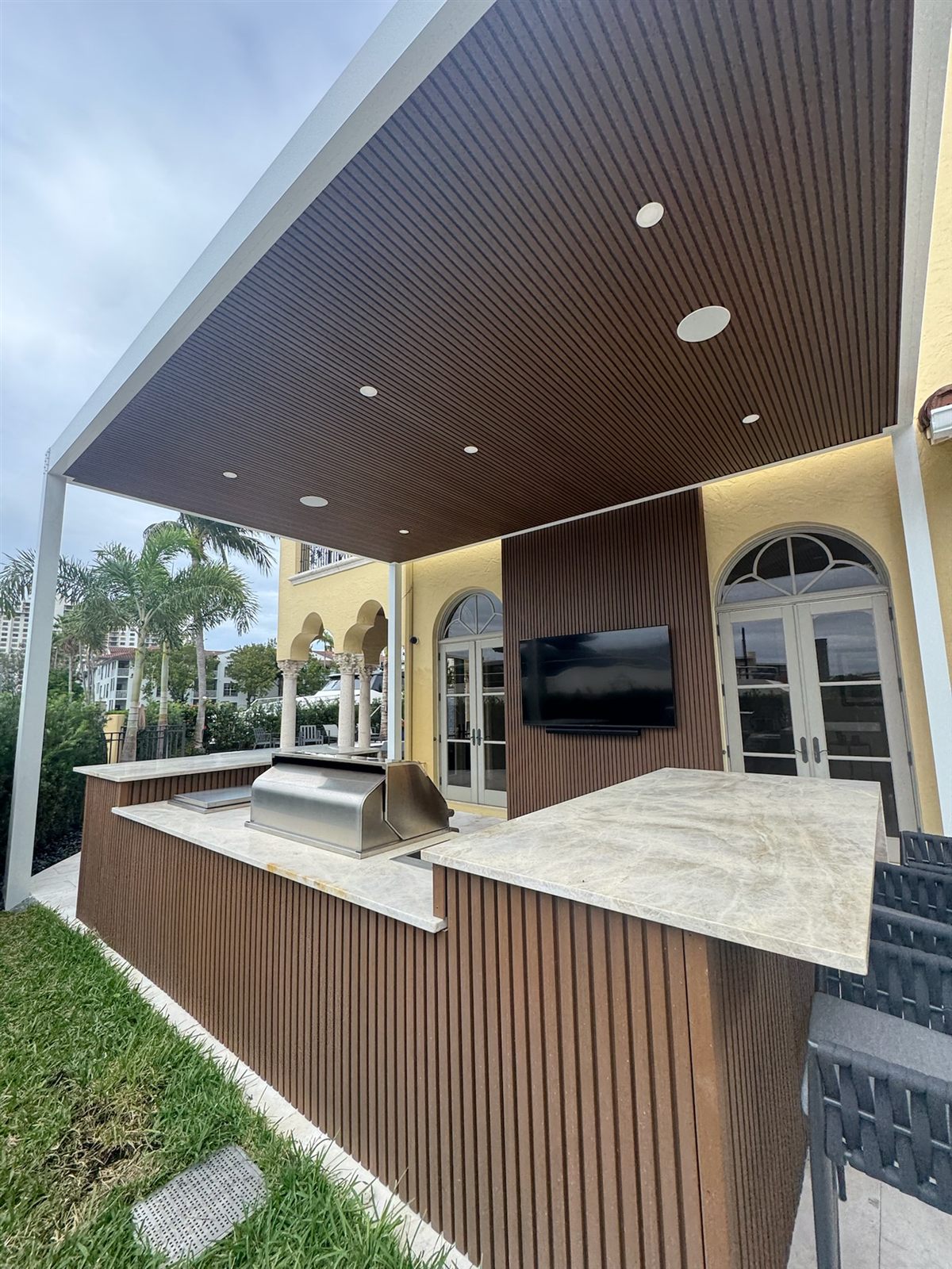 Outdoor kitchen with grill under the pergola